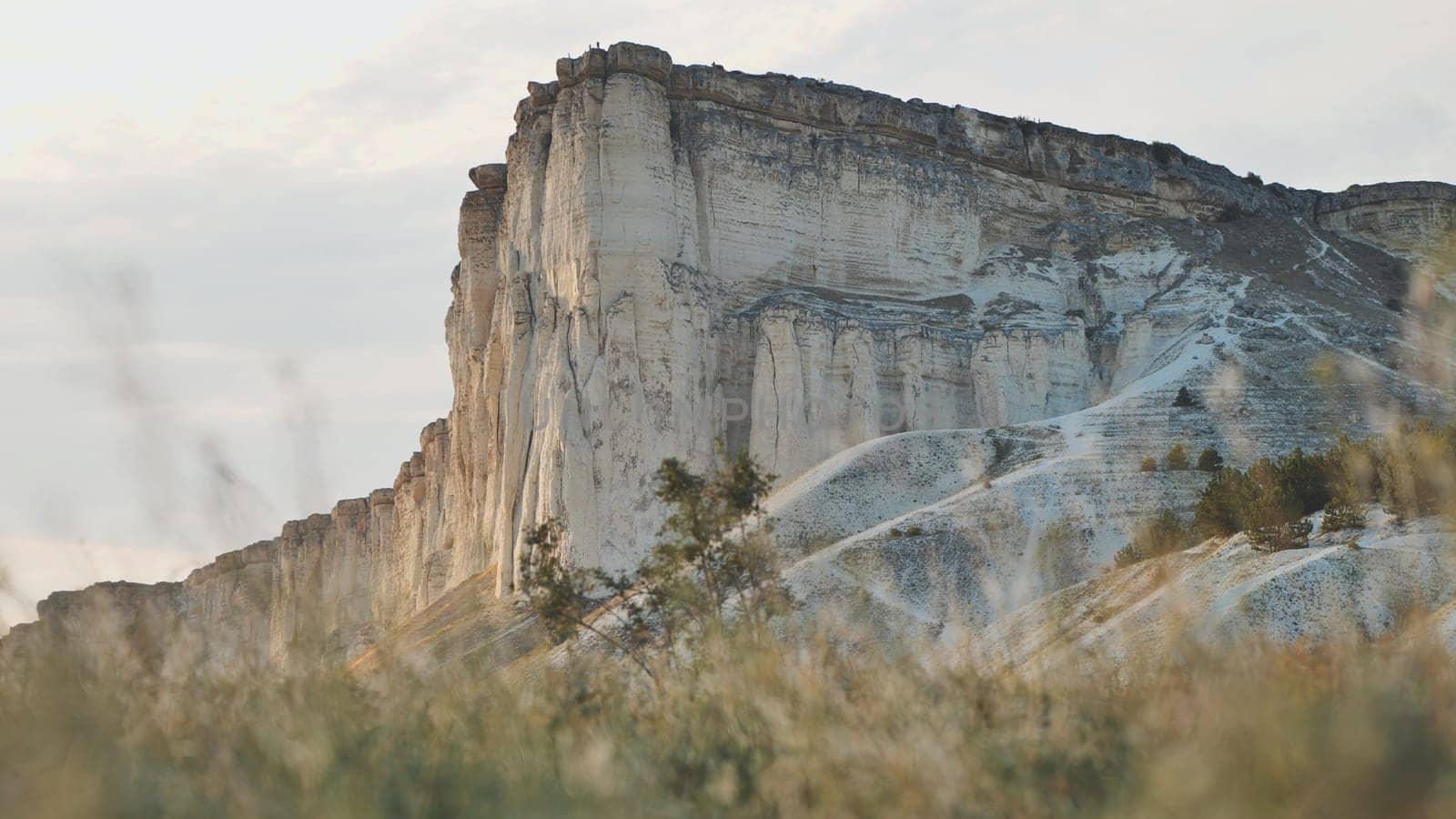 Golden sunlight illuminating rugged white rock mountain terrain with dramatic geological features in crimean landscape