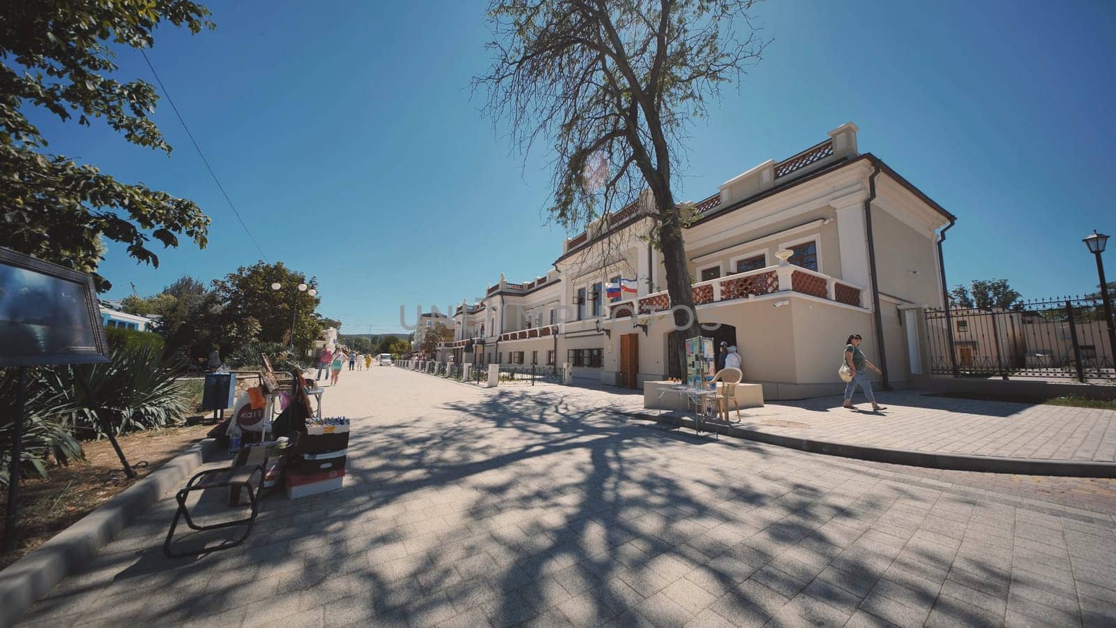 Tourists walking near the elegant building of the Simferopol International Airport in Crimea on a sunny summer day