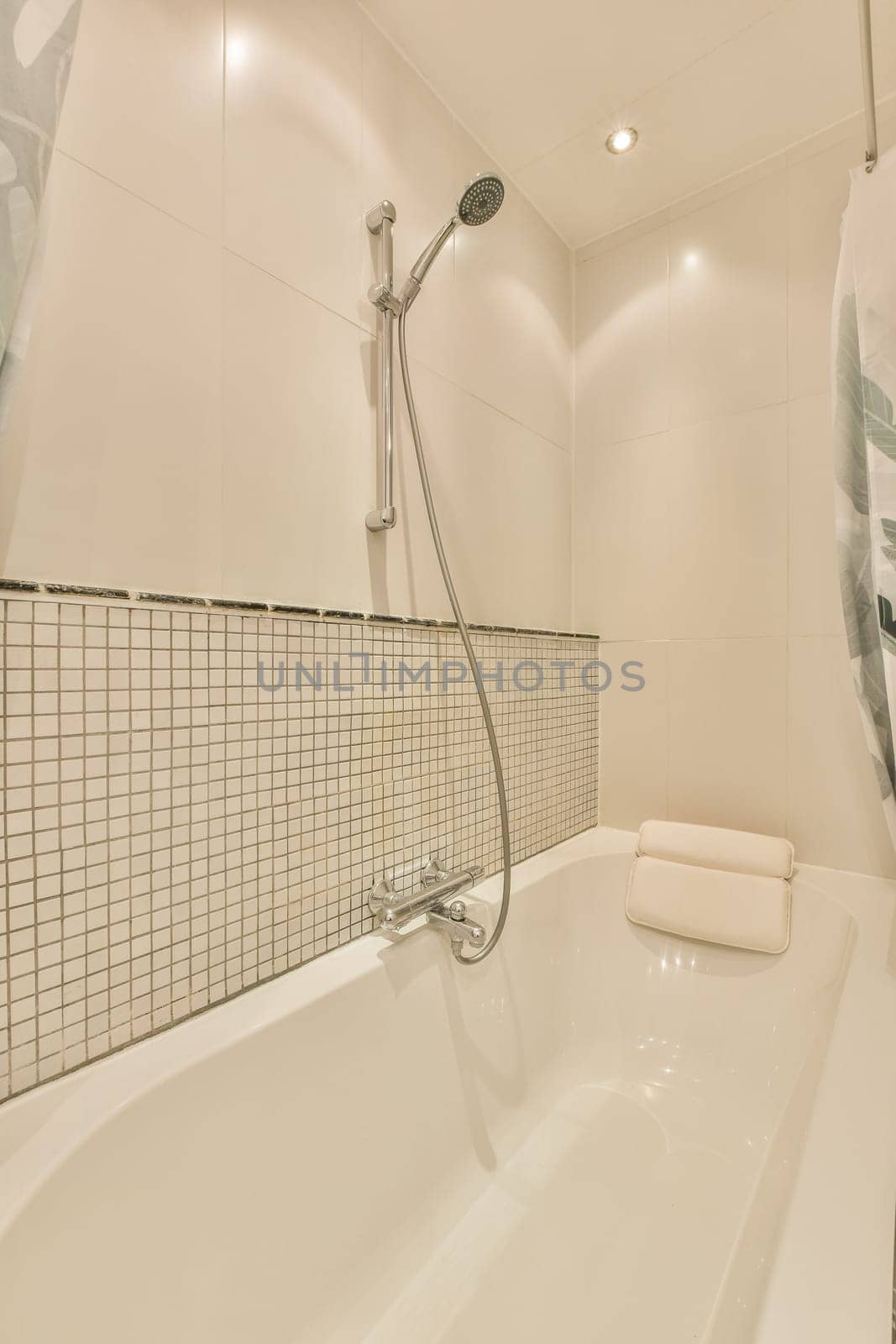 a man in the shower is on the wall above the bathtub and it's next to the toilet
