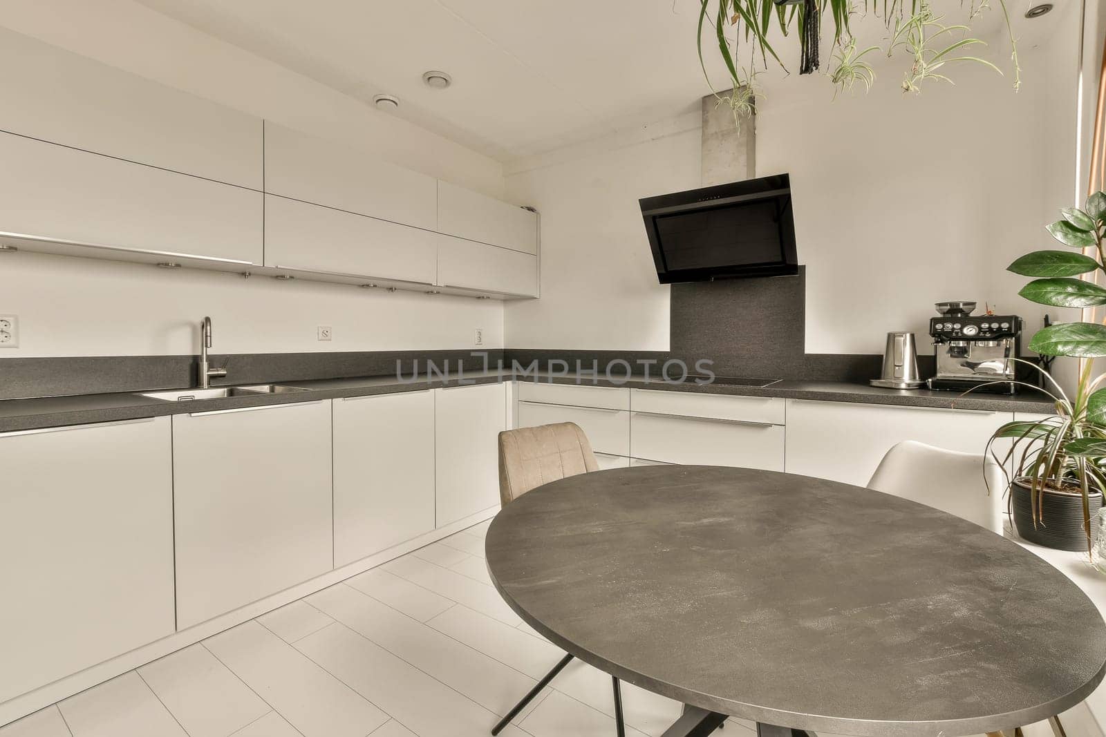 a small kitchen with white cabinets and black counter tops on the counters in this photo is taken from the inside