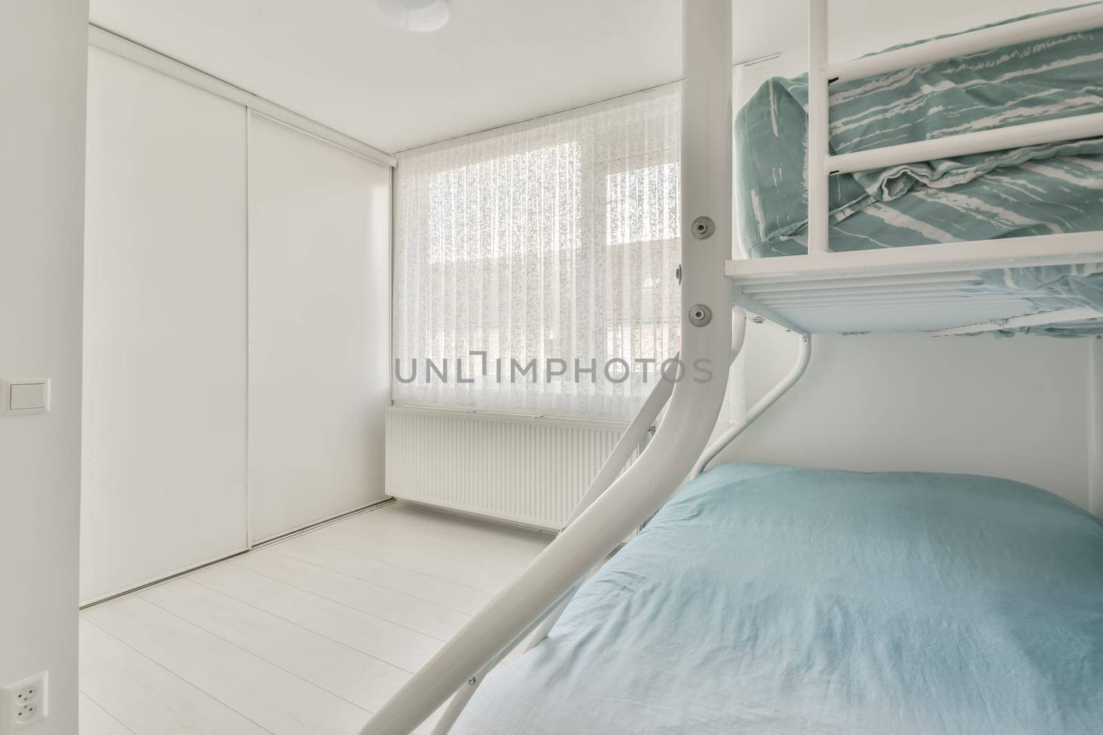 a bedroom with bunks and a bed in the middle part of the room there is a window to the outside