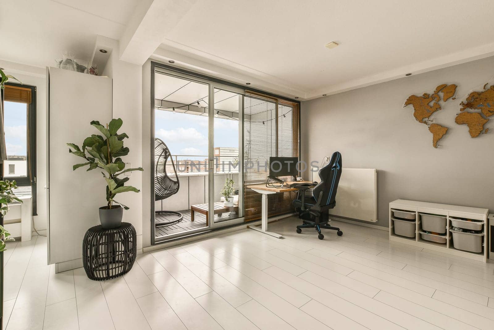 a living room with a desk, chair and large window looking out onto the cityscapearl view