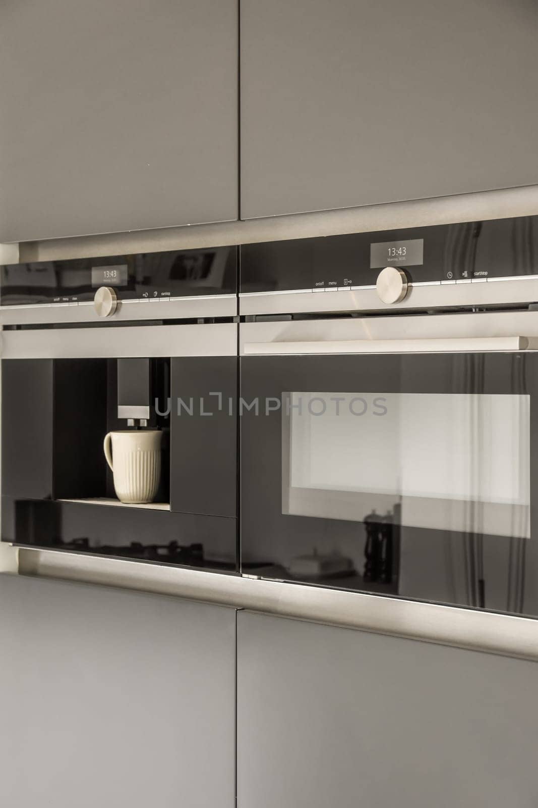 a modern kitchen with black and white appliances on the counter tops, including an oven hood in the middle part