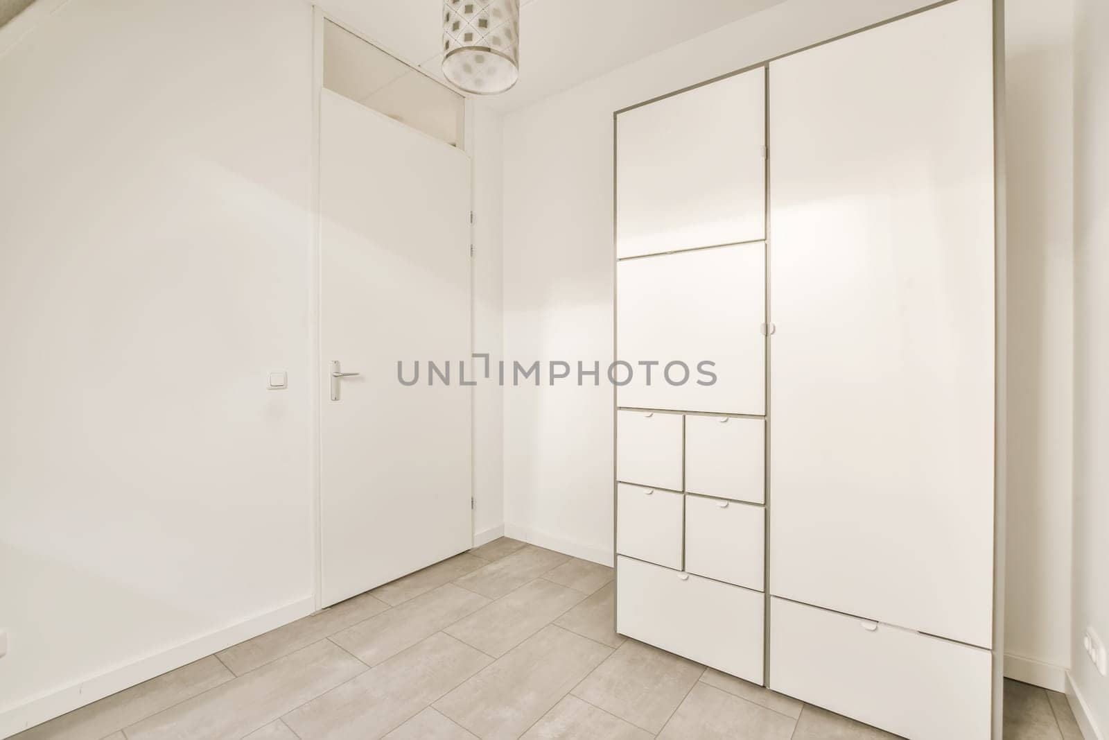 an empty room with white walls and wood flooring, there is a mirror on the wall in the corner