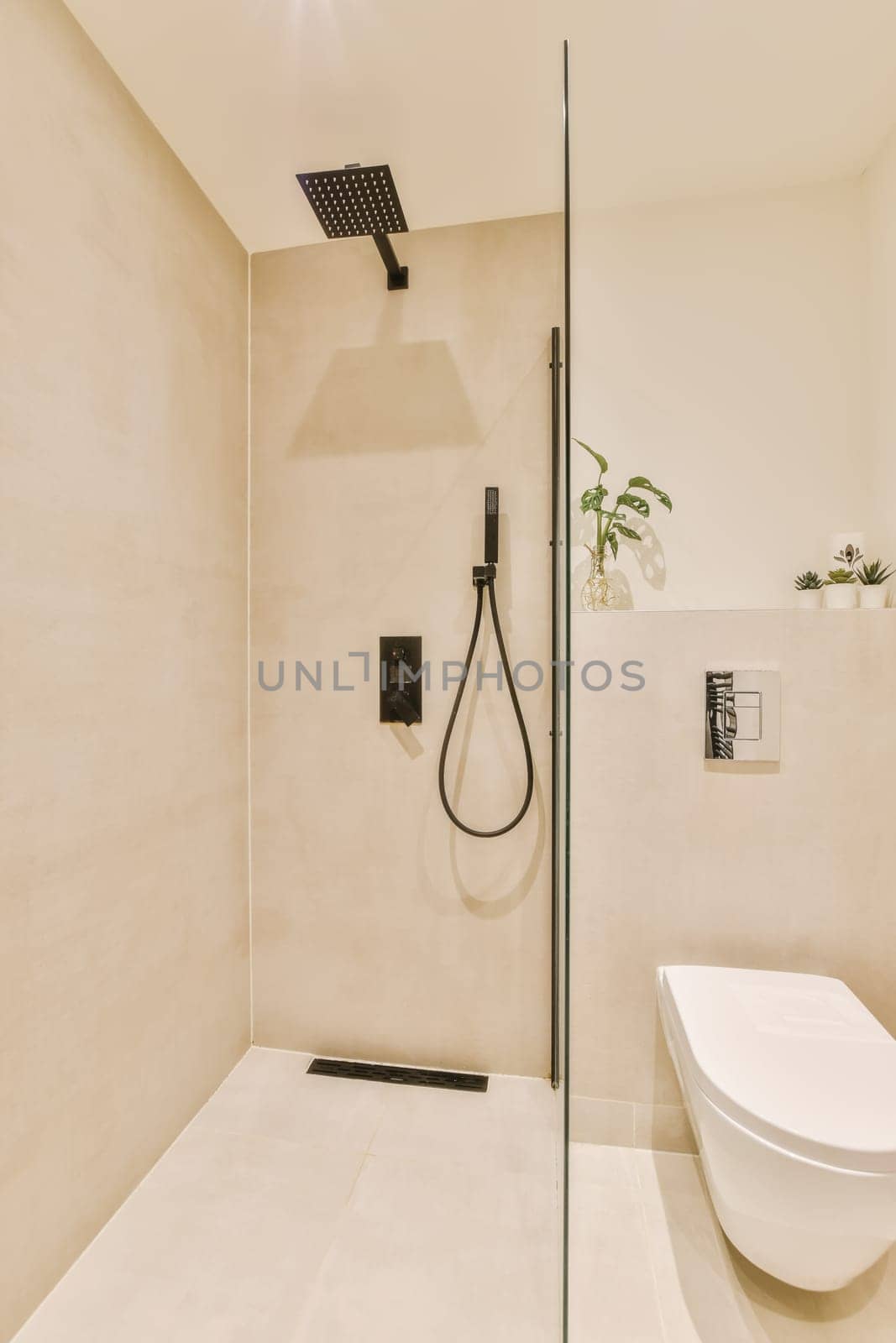 a modern bathroom with white walls and beige flooring, including a walk - in shower stall attached to the wall