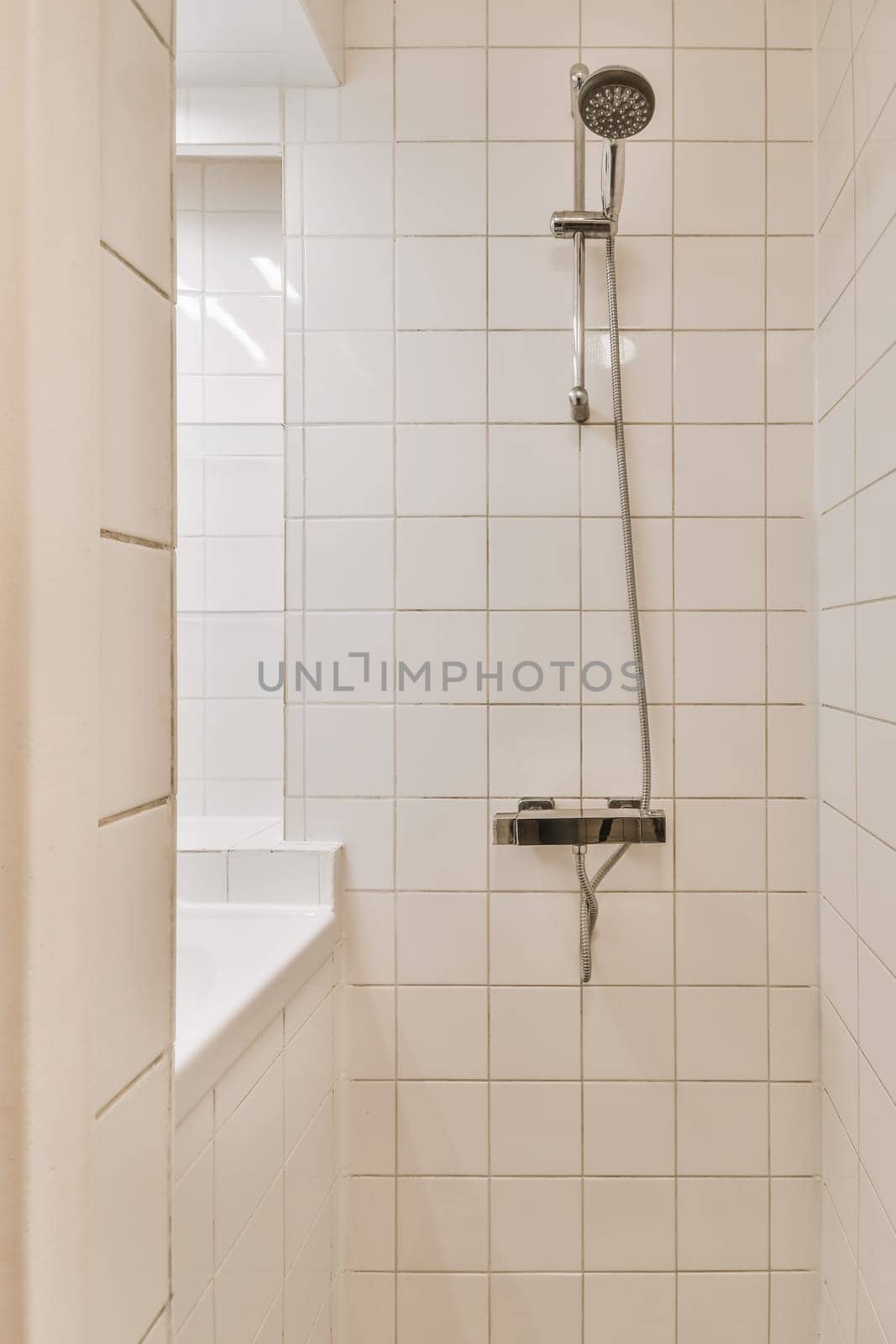 a shower with white tiles on the walls and floor in a small bathroom area next to a window that is open