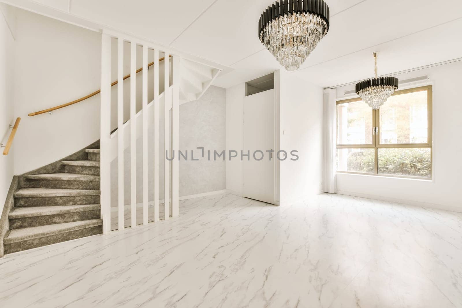 an empty living room with marble flooring and white walls there is a chandel hanging from the ceiling light