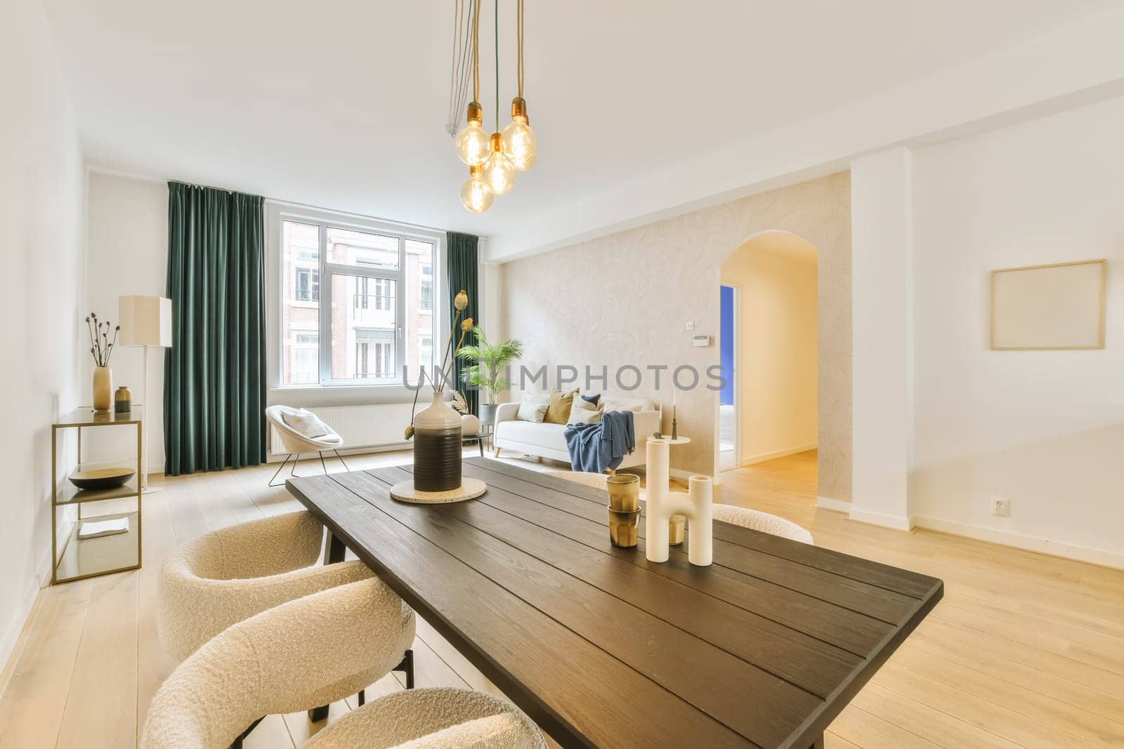 a dining room with chairs and a wooden table in front of a large window that looks out onto the street