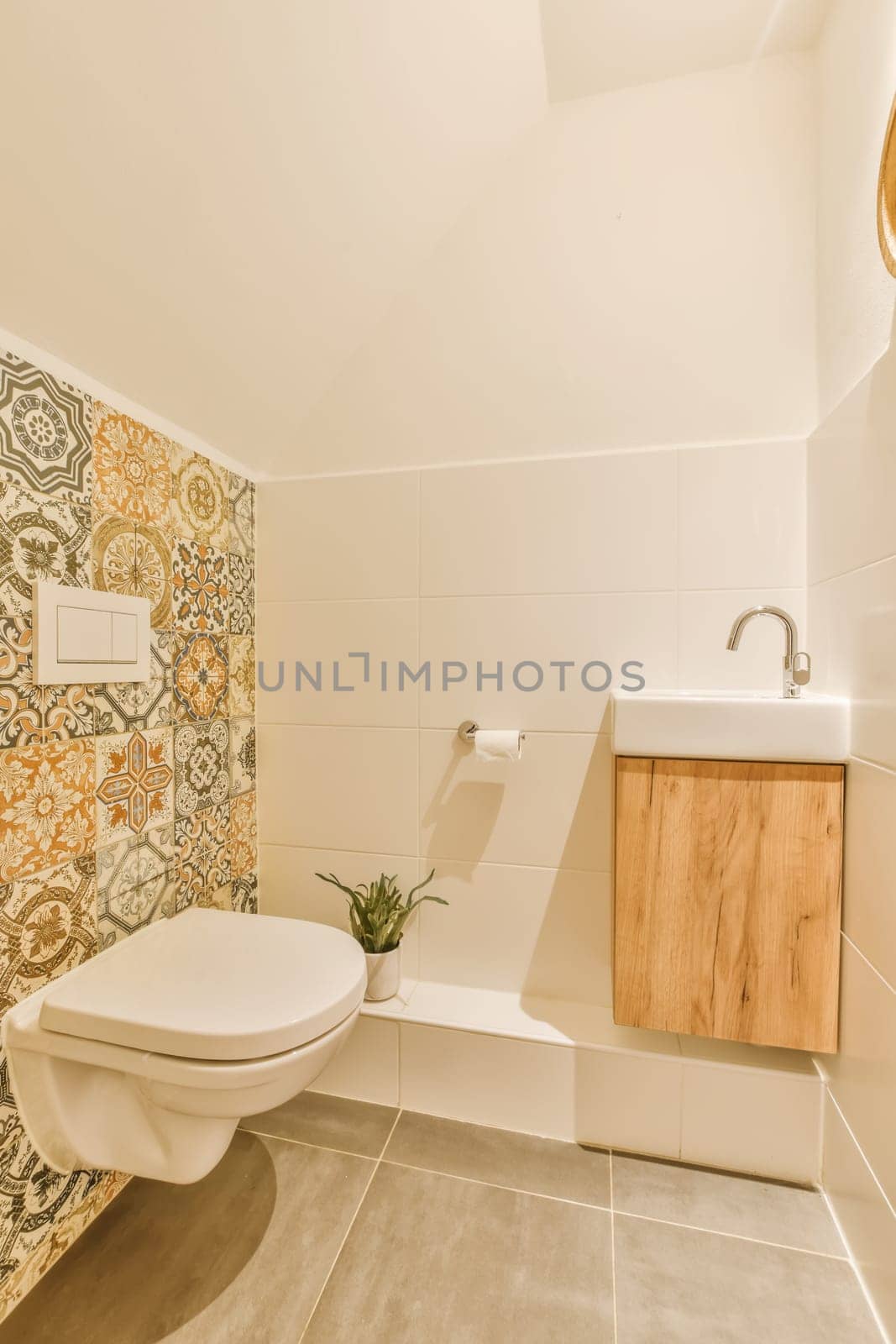 a bathroom with an artistic design on the wallpaper and toilet in the room is white, beige and orange