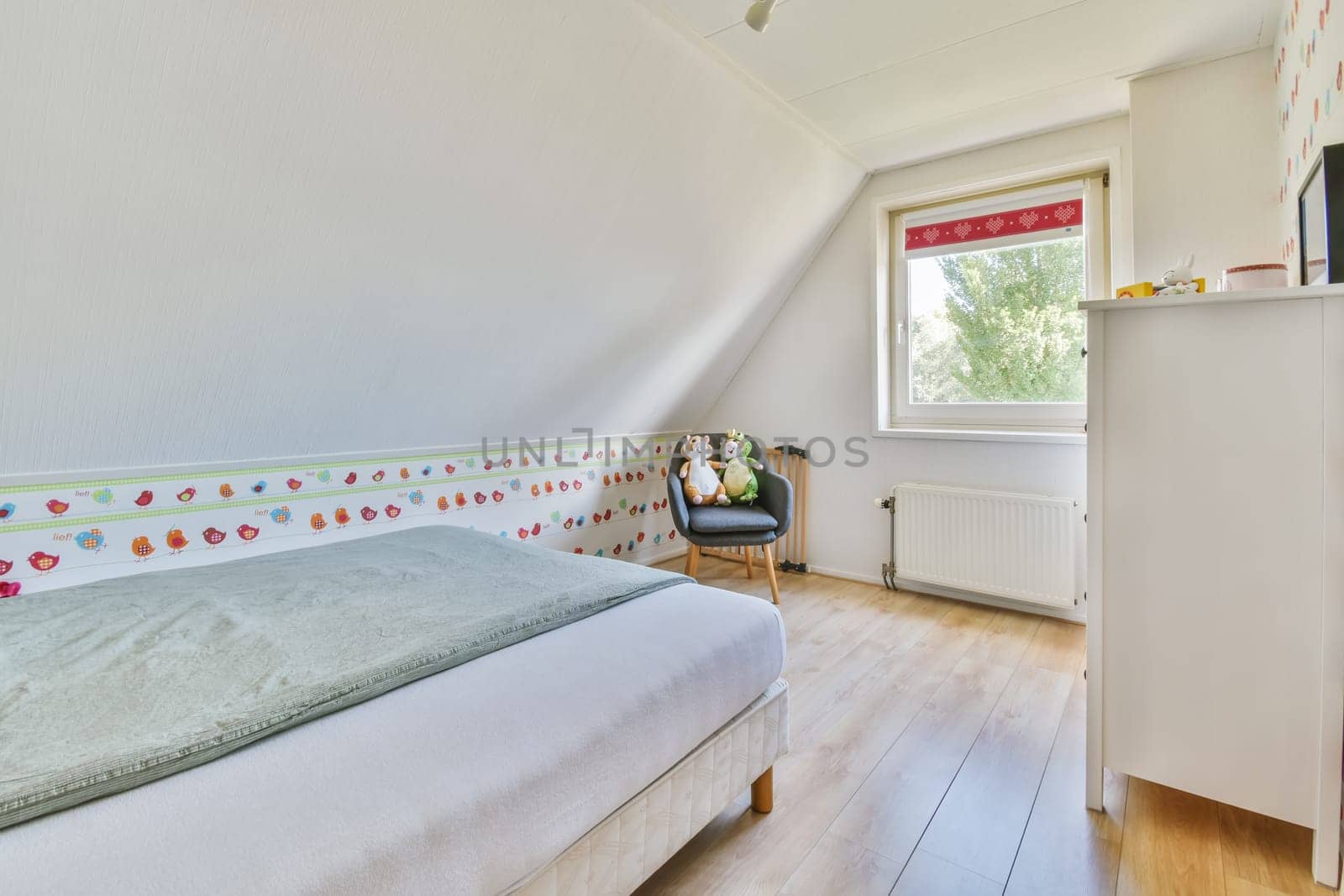 a child's room with a bed, dresser and tv on the wall in the room is bright white