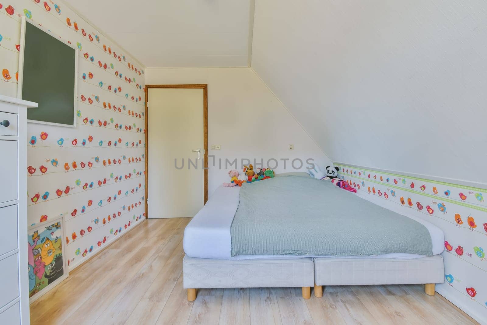 a child's bedroom with colorful wallpapers on the walls and white furniture in front of the bed