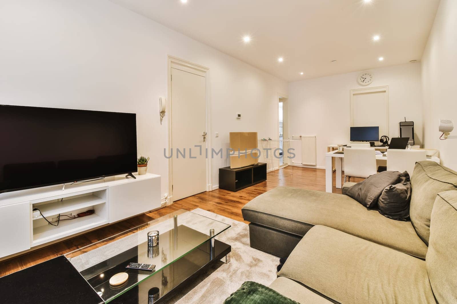 a living room with couch, tv and coffee table in the photo is taken to the right side of the room