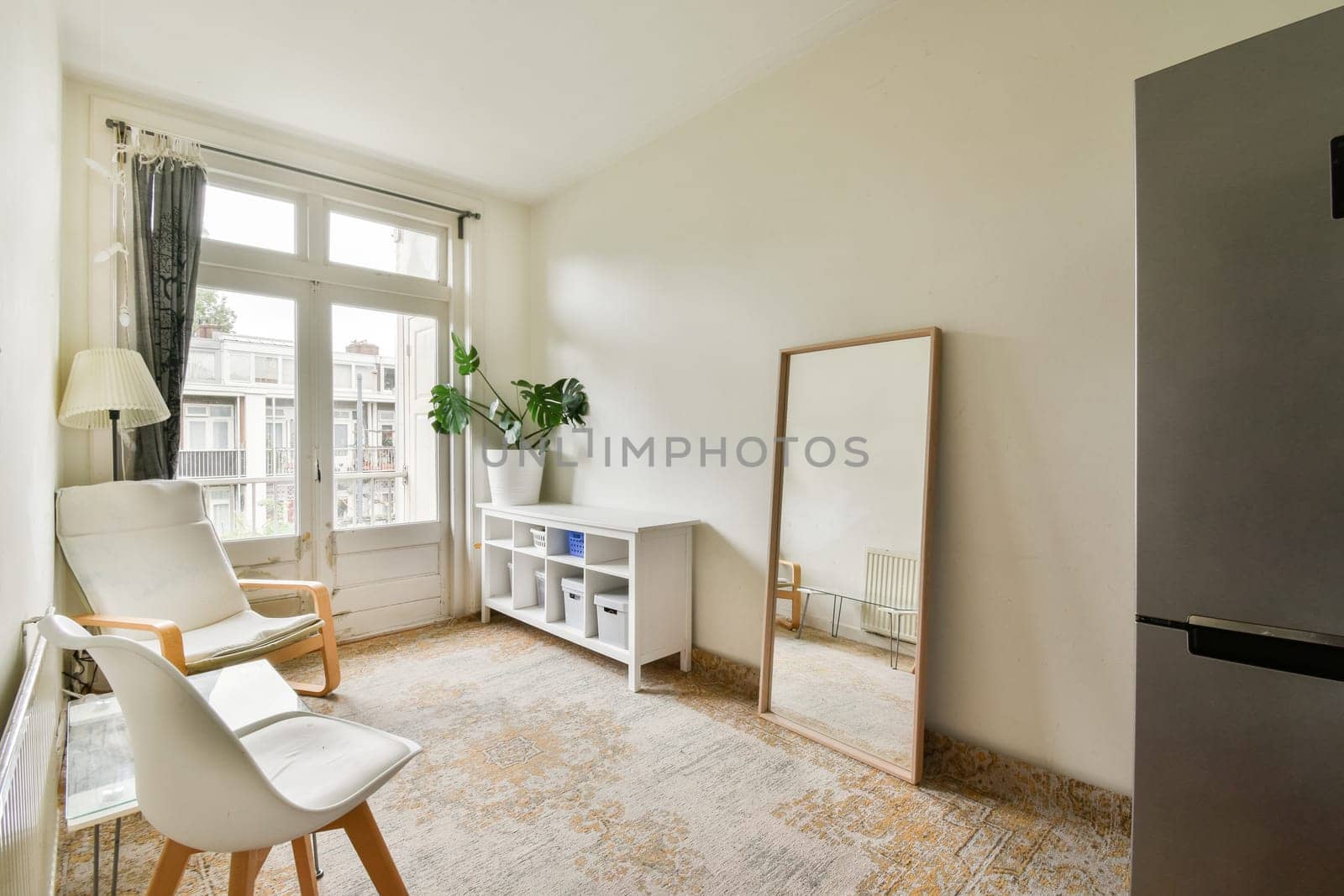 a living room with a chair, table and television on the wall in front of the tv is not visible