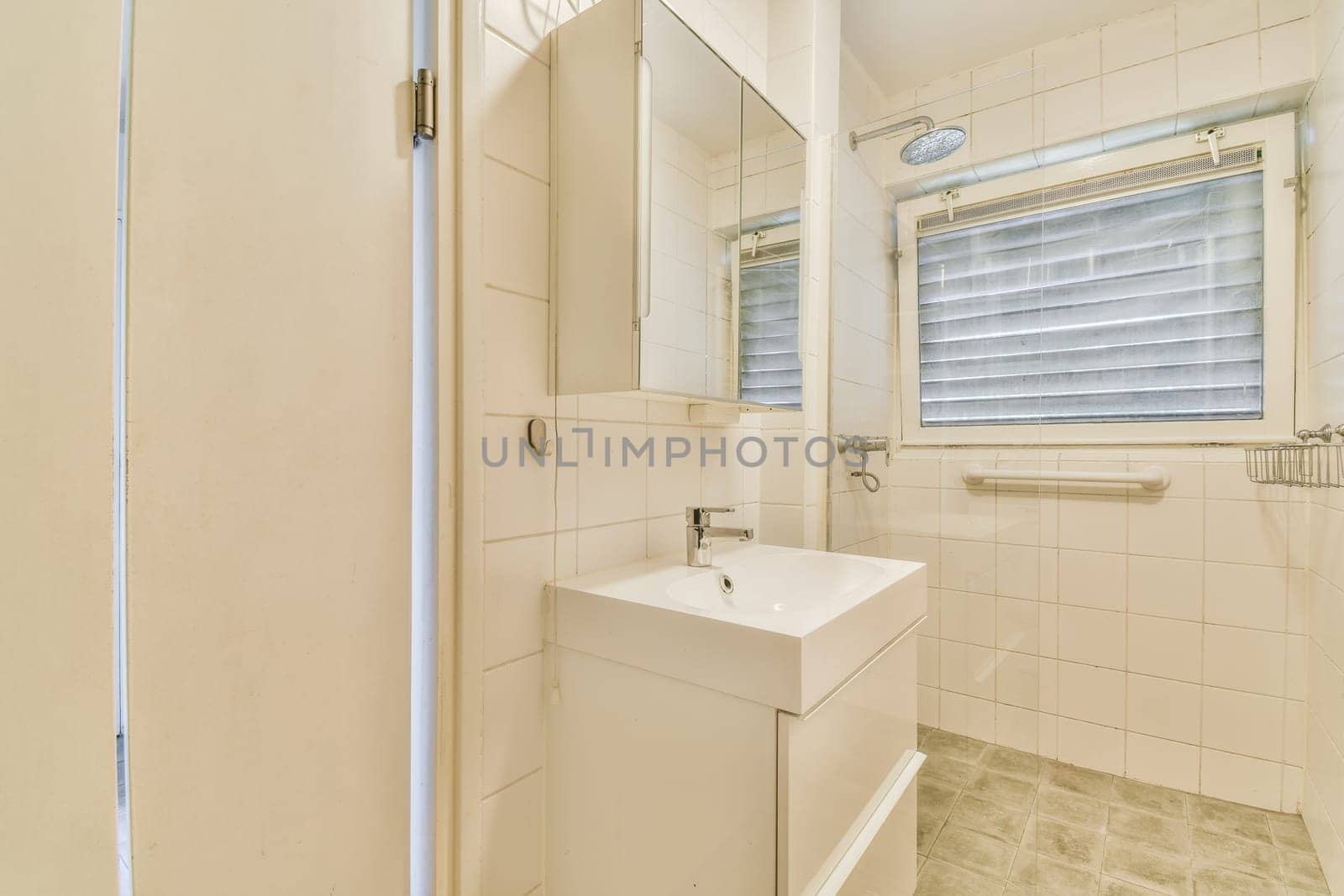a small bathroom with a sink and mirror on the wall next to the shower stall in the room is very clean