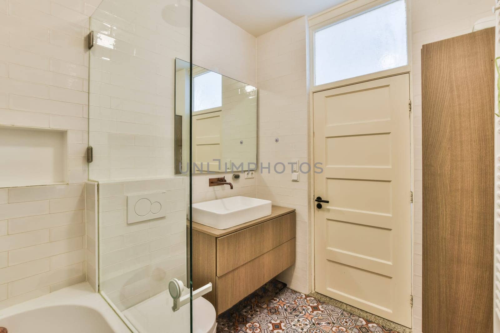 a bathroom with a sink, mirror and toilet paper on the floor in front of the door to the shower room
