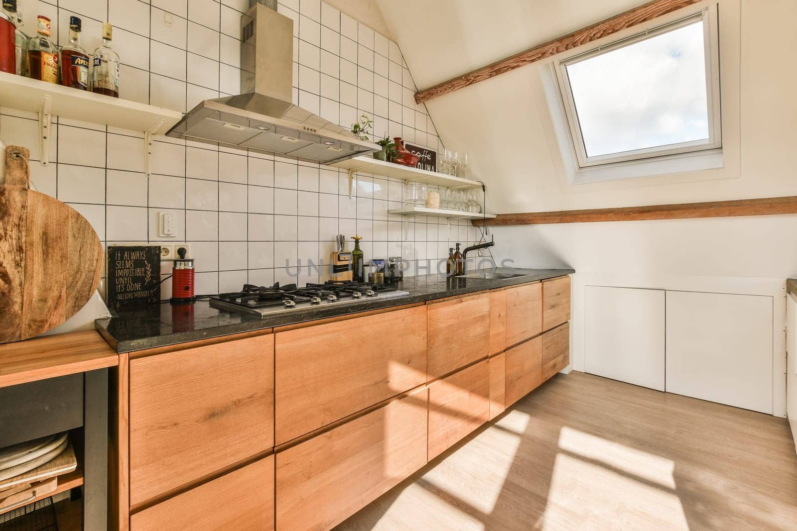 a kitchen with wood cabinets and black counter tops in the center of the image is an open skylight window