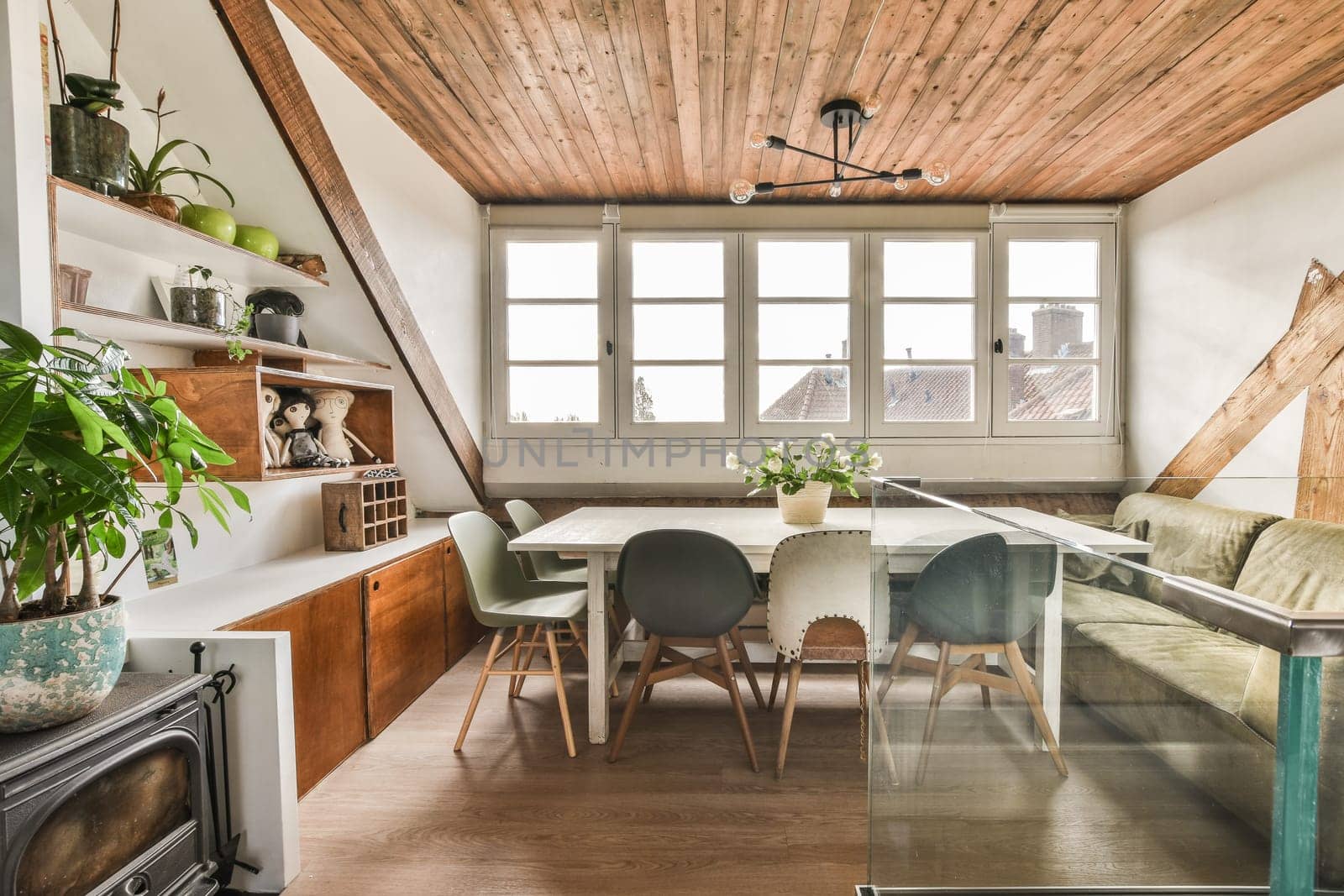 a kitchen and dining area in a house with wood floors, white walls, wooden ceiling, and green chairs
