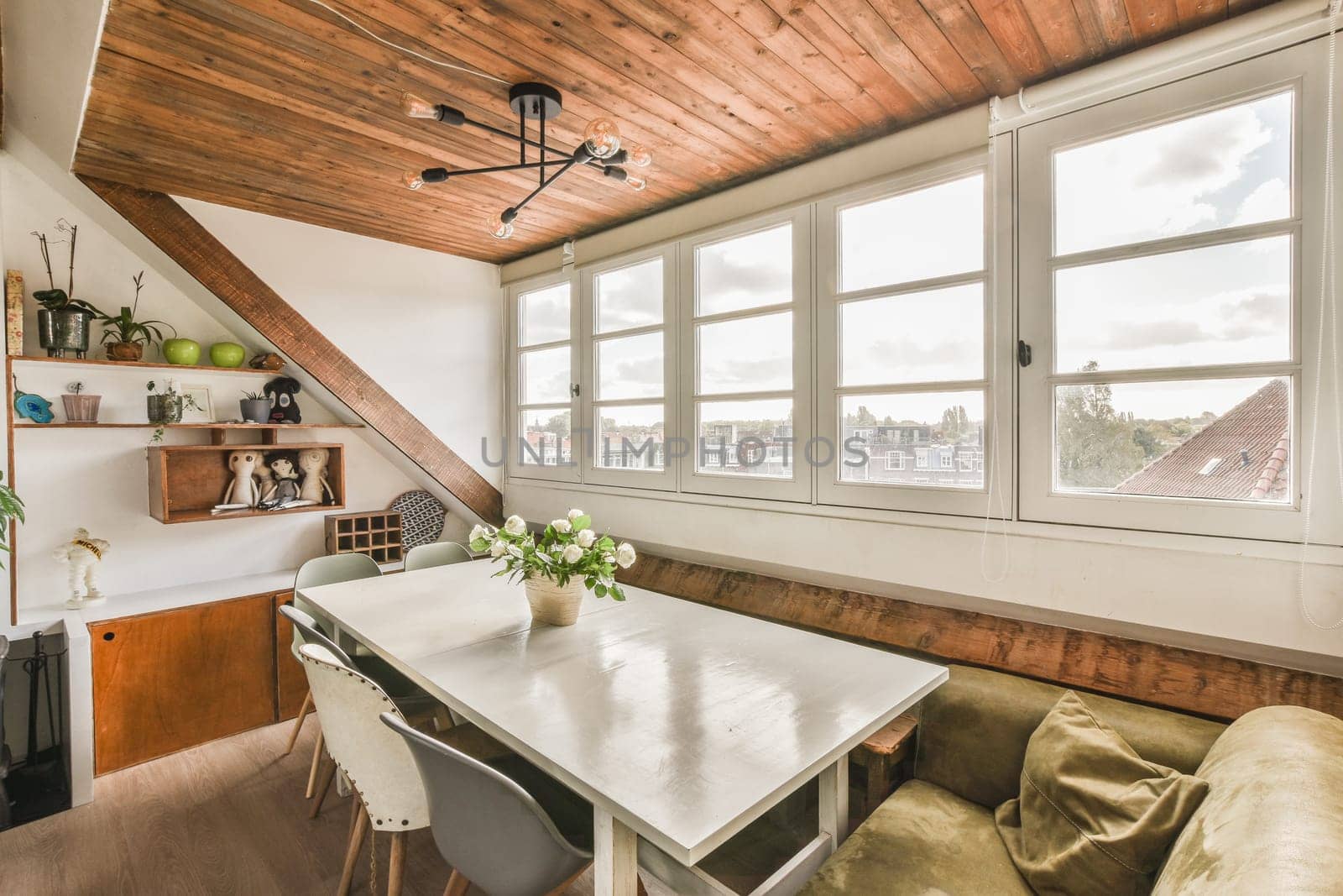 a kitchen and dining area in a house with wooden ceilings, white walls and wood flooring on the ceiling