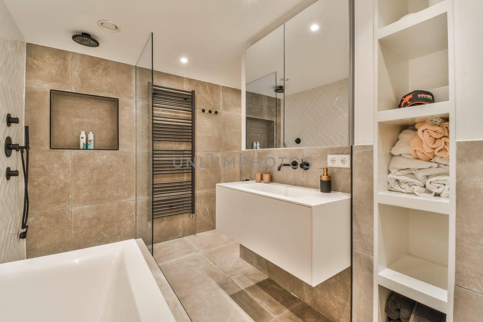 a modern bathroom with beige tiles and white fixtures on the walls, along with a glass shower stall in the corner