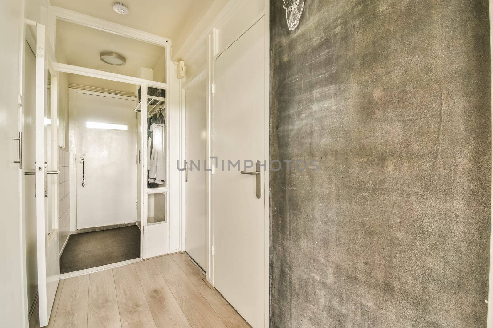 an empty room with wood flooring and white trim on the walls, including a large mirror in the door