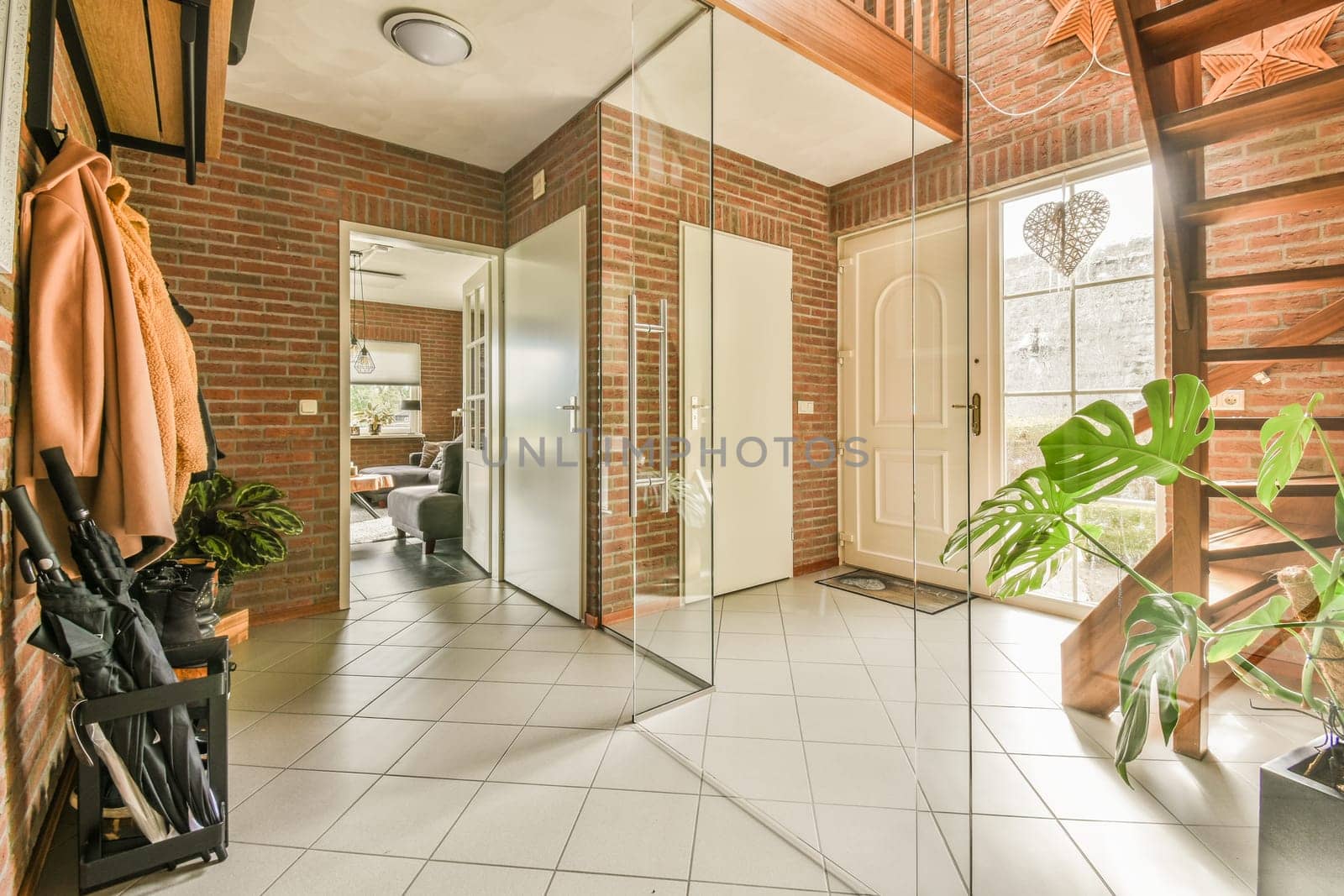 a bathroom with red brick walls and white tile flooring that has been used as an entrance way to the room