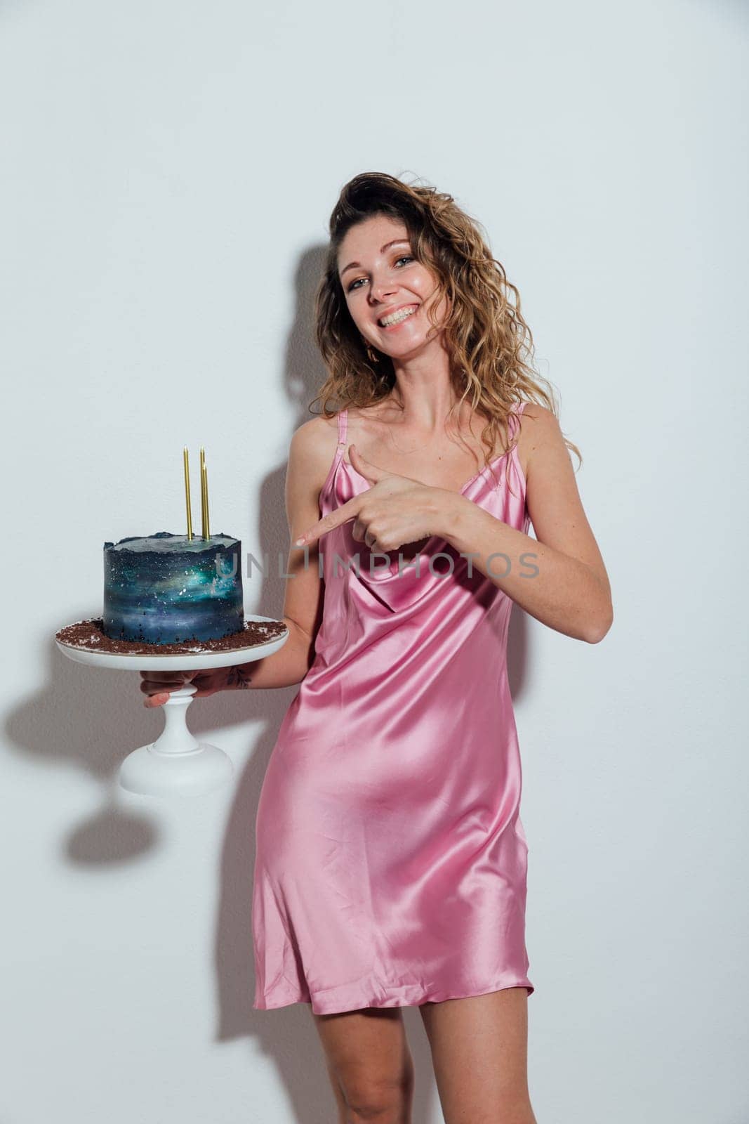Beautiful slender woman pastry chef with birthday cake smiling