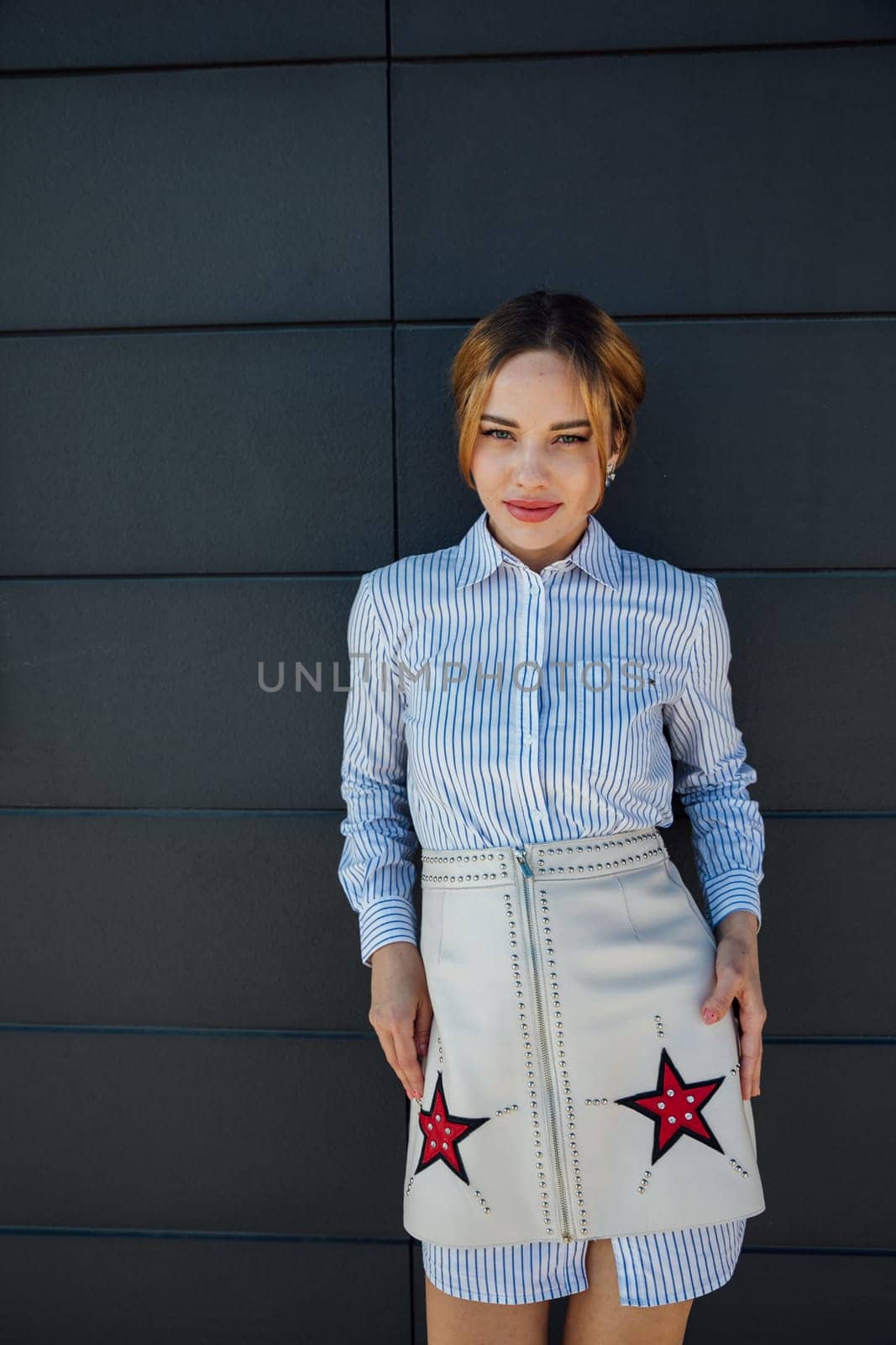 Portrait of a beautiful slender woman fashionably walking on the street