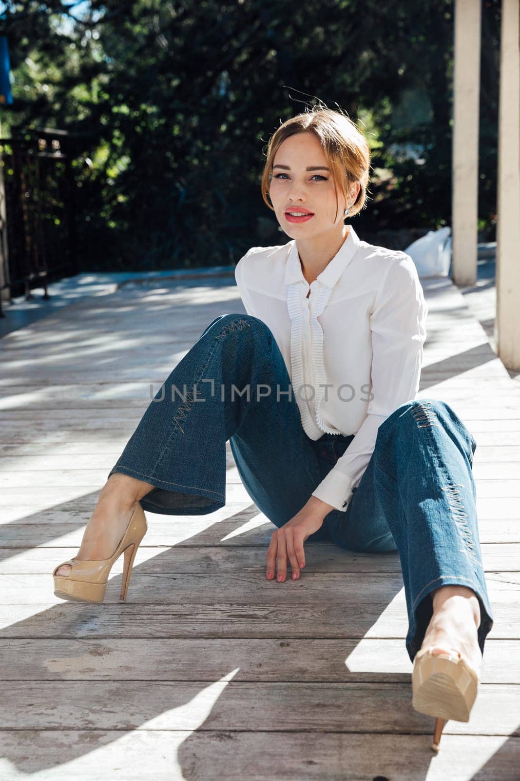 Portrait of a beautiful slender blonde woman fashionably walking on the street