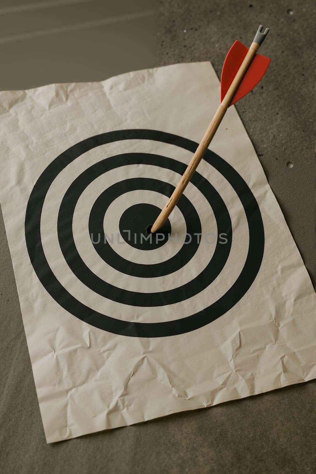 Dart in target on crumpled paper, AI generation.
