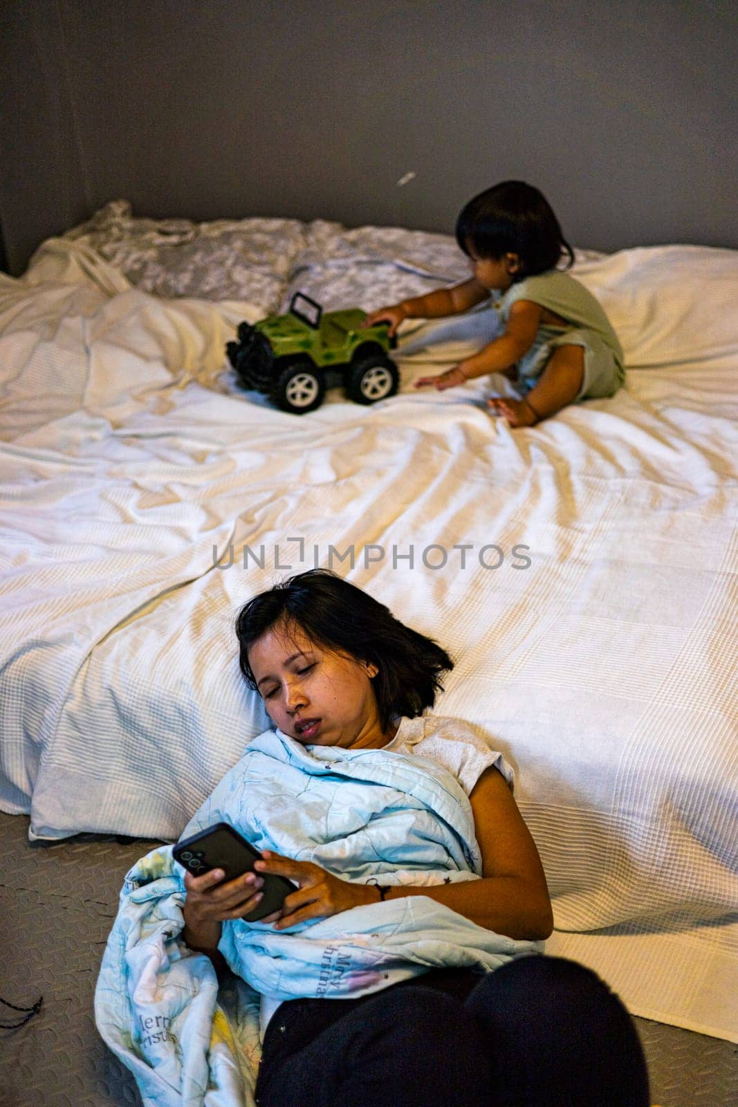 Mother Was Lying On The Floor Because She Was Tired From Taking Care Of The Child, Background for advertising and wallpaper in relaxion and lifestyle scene.