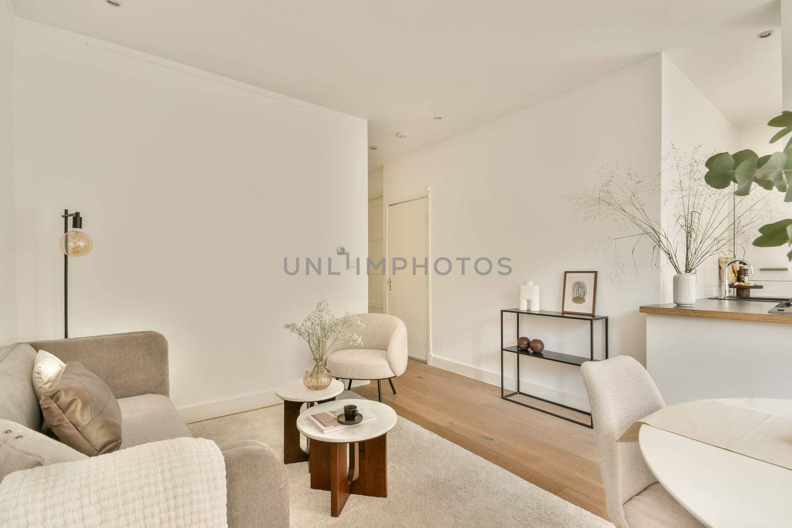 A stylish modern living room featuring neutral colors, elegant furniture, and decorative elements that create a warm and inviting atmosphere.