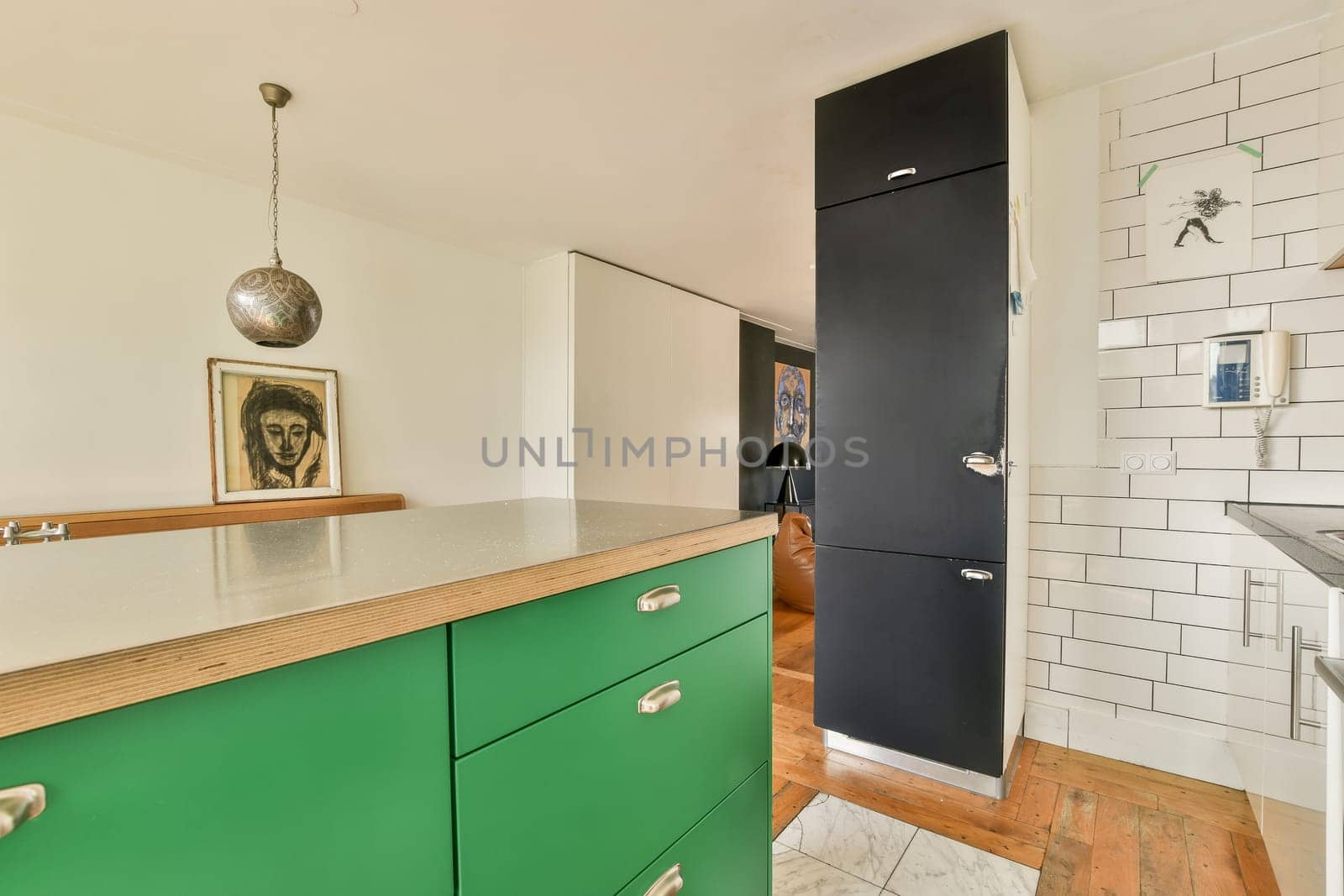 Stylish modern kitchen featuring vibrant green cabinets, a minimalist design, and contemporary decor elements, creating an inviting and functional space.