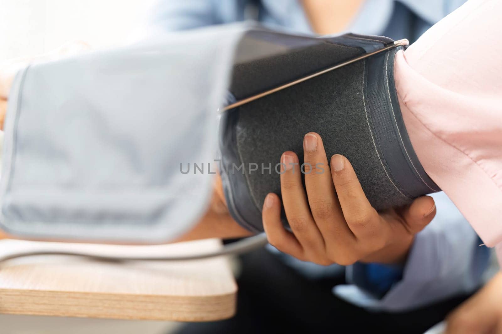 A nurse carefully assesses the patient's blood pressure, demonstrating the importance of monitoring vital signs for overall health.
