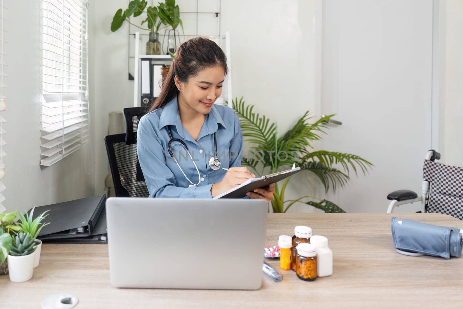 With a focus on organization, a nurse records important health information, emphasizing thoroughness in patient management.
