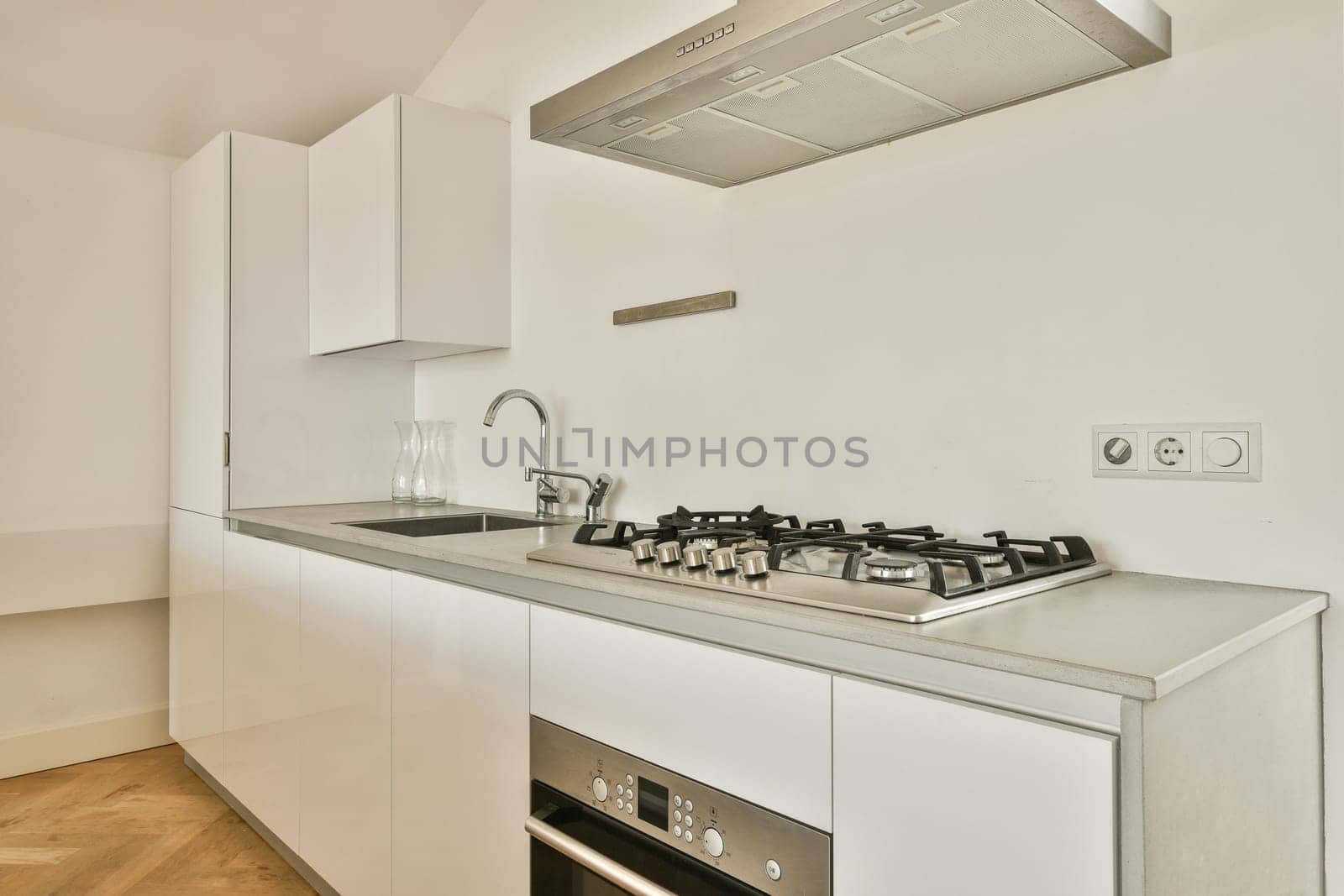 A sleek and contemporary kitchen showcasing minimalist cabinetry, stainless steel appliances, and a clean aesthetic. Perfect for modern living spaces.