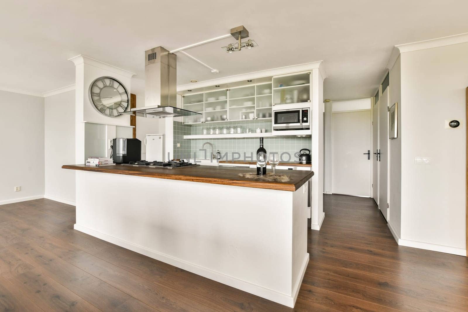 A sophisticated modern kitchen featuring a wooden countertop, stainless steel appliances, and stylish decor, perfect for culinary enthusiasts and home gatherings.