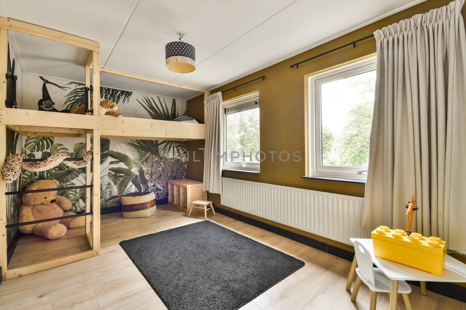 A contemporary children's room featuring a wooden bunk bed, playful decor, and vibrant wall art, creating a cheerful and inviting atmosphere.