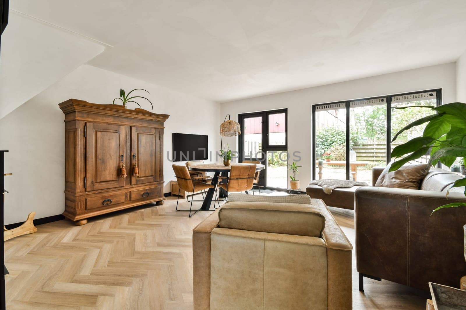 A modern living room featuring stylish furniture, natural light, and decorative elements that create a comfortable and inviting atmosphere.