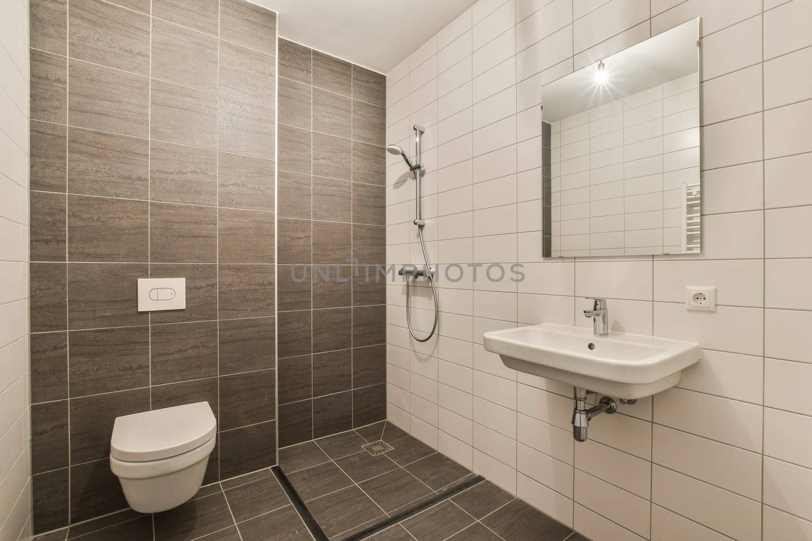 A sleek and contemporary bathroom showcasing a stylish shower area with elegant tiles and minimalistic fixtures, perfect for modern living.