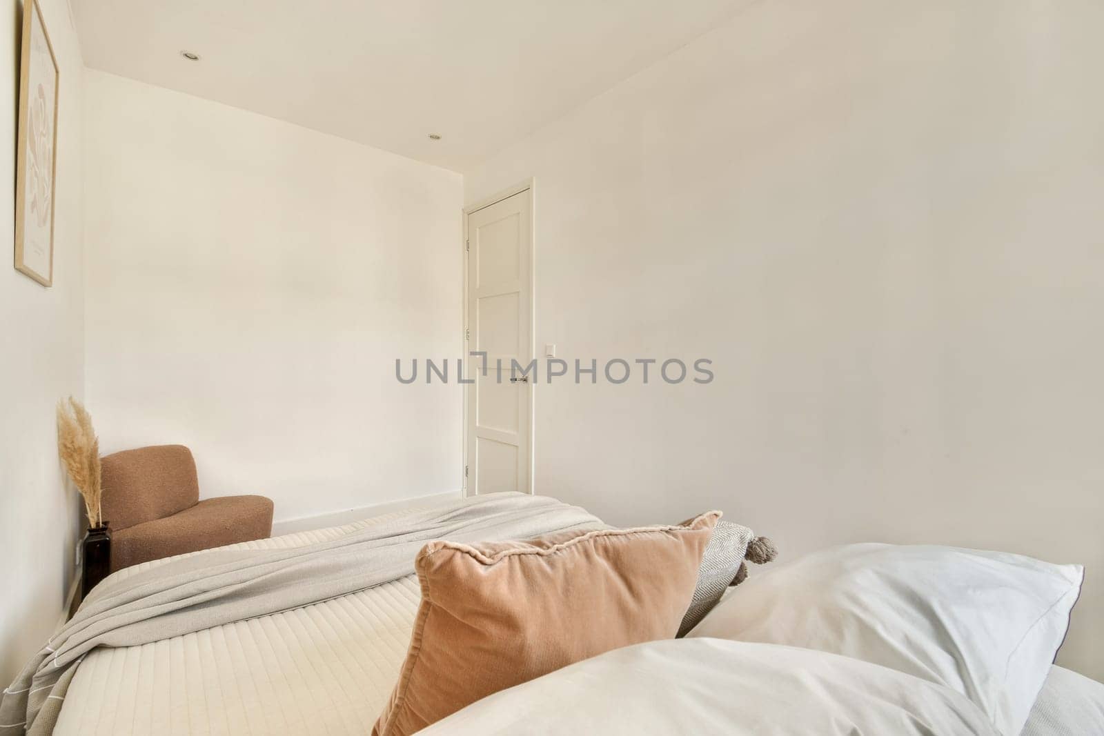 A serene and minimalist bedroom featuring soft textures and neutral colors, providing a peaceful and relaxing atmosphere for rest.