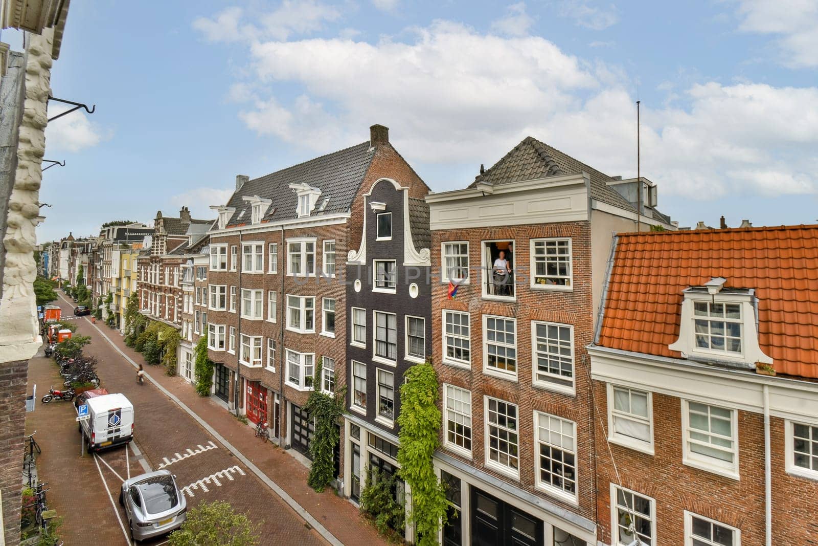 Beautiful view of traditional Dutch houses lining a canal, showcasing distinctive gabled roofs and vibrant facades against a clear sky.