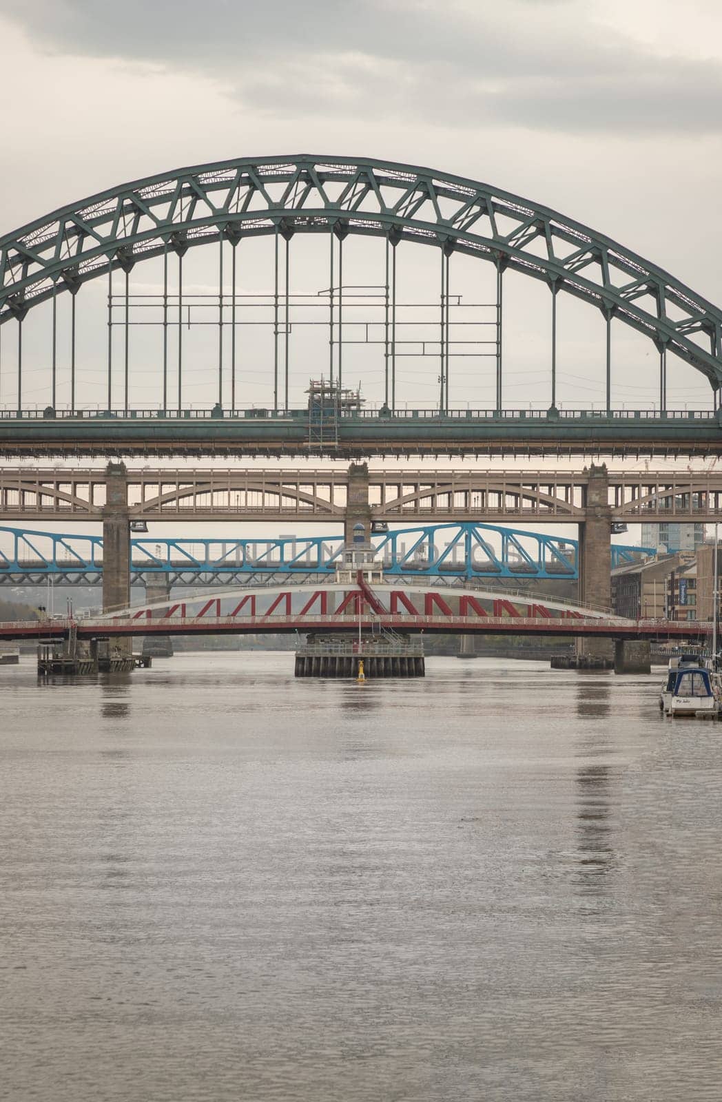 Newcastle, UK - Apr 12, 2025 - Stunning view of the Newcastle upon tyne with Tyne bridge, Swing bridge and The High level bridge spanning the River Tyne connecting Newcastle upon tyne and Gateshead in North East England before sunset. use it as your Wallpaper, Poster and Copy space, Selective focus.