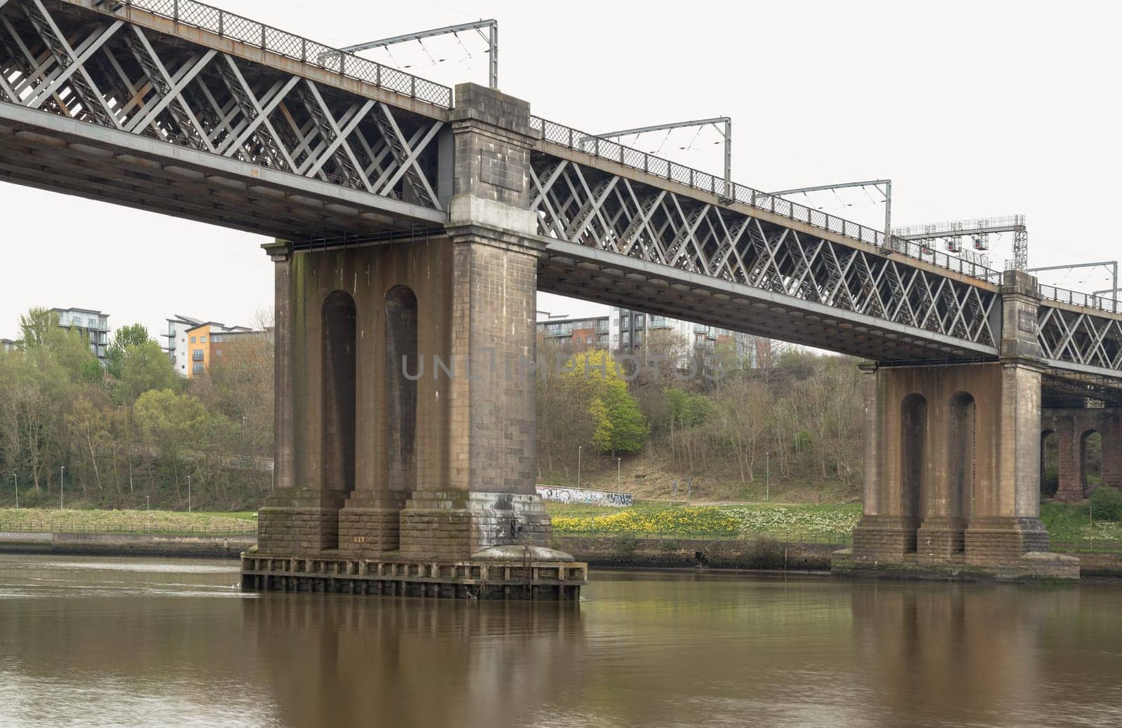 Newcastle, UK - Apr 12, 2025 - A view of The King Edward VII Bridge (Railway viaduct) is a railway bridge spanning the River Tyne between Newcastle upon tyne and Gateshead in the North East of England. King Edward VII Bridge has been described as “Britain’s last great railway bridge”, use it as your Wallpaper, Poster and Space for text, Selective focus.