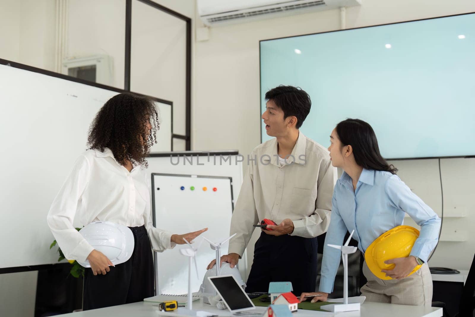 A committed team shares ideas around sustainable design, emphasizing the importance of ESG factors in their project planning and execution in a collaborative atmosphere.