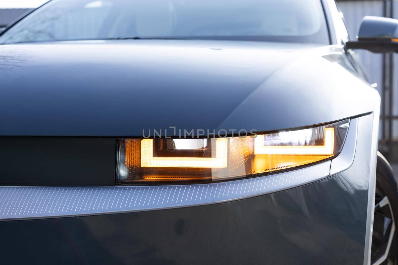 Car flashing light with blinking indicator. Emergency flashing car light lamp, warning sign. LED Headlight of a car Shining. Led light of a car shining bright. Nobody around to help