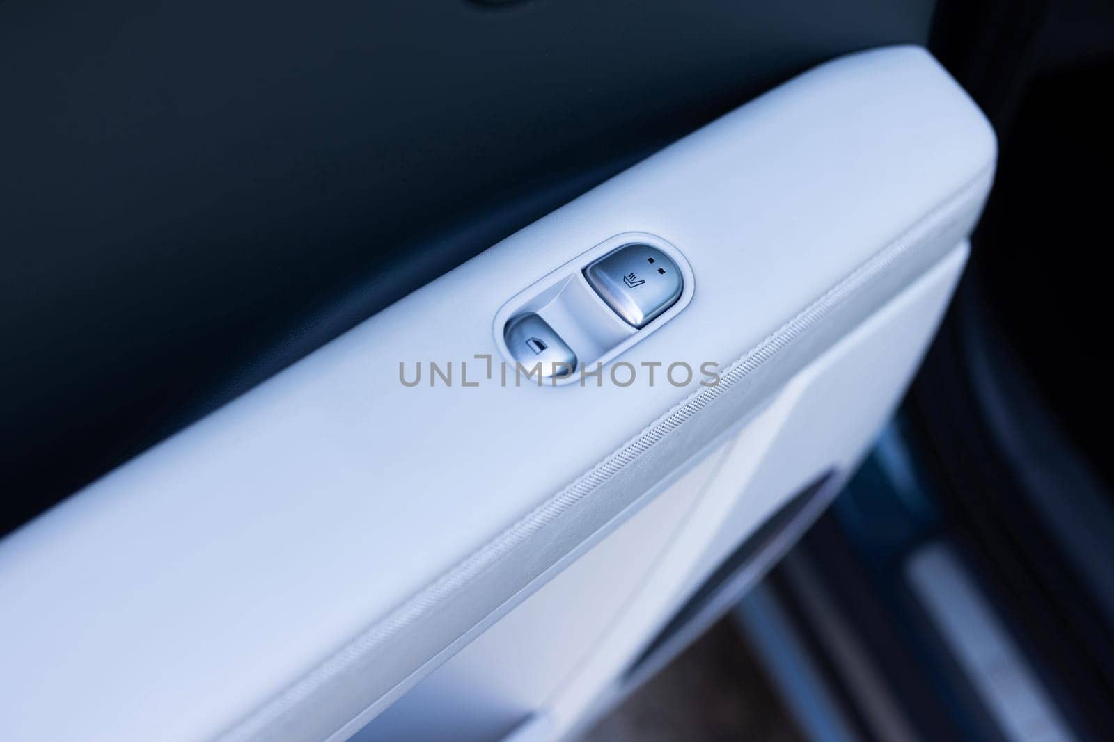 Rear passengers Seat heater button, car interior. Double seat heating switch in a car. Button for heating the rear of seats. Rear seat heated seat controls.