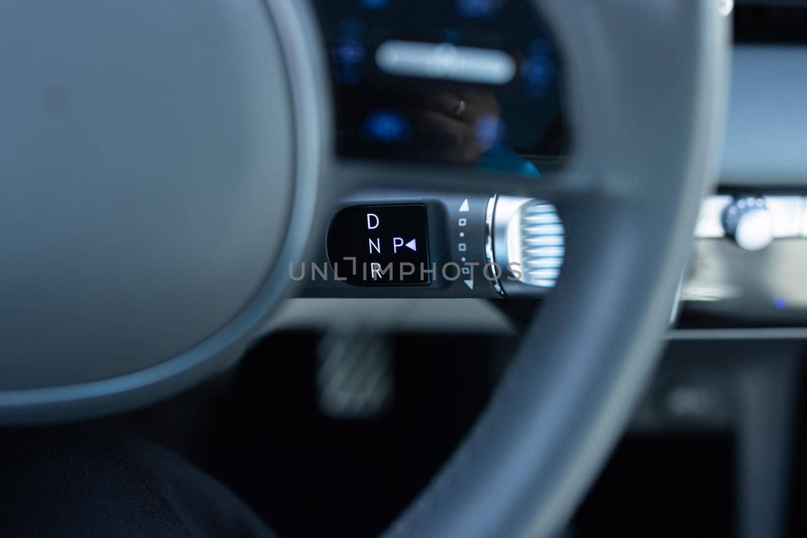 Handle of electric car gearbox control. Design details of minimalist concept of electric car. Close-up of details of automatic transmission and gear stick. Automatic gear lever and gear shift.