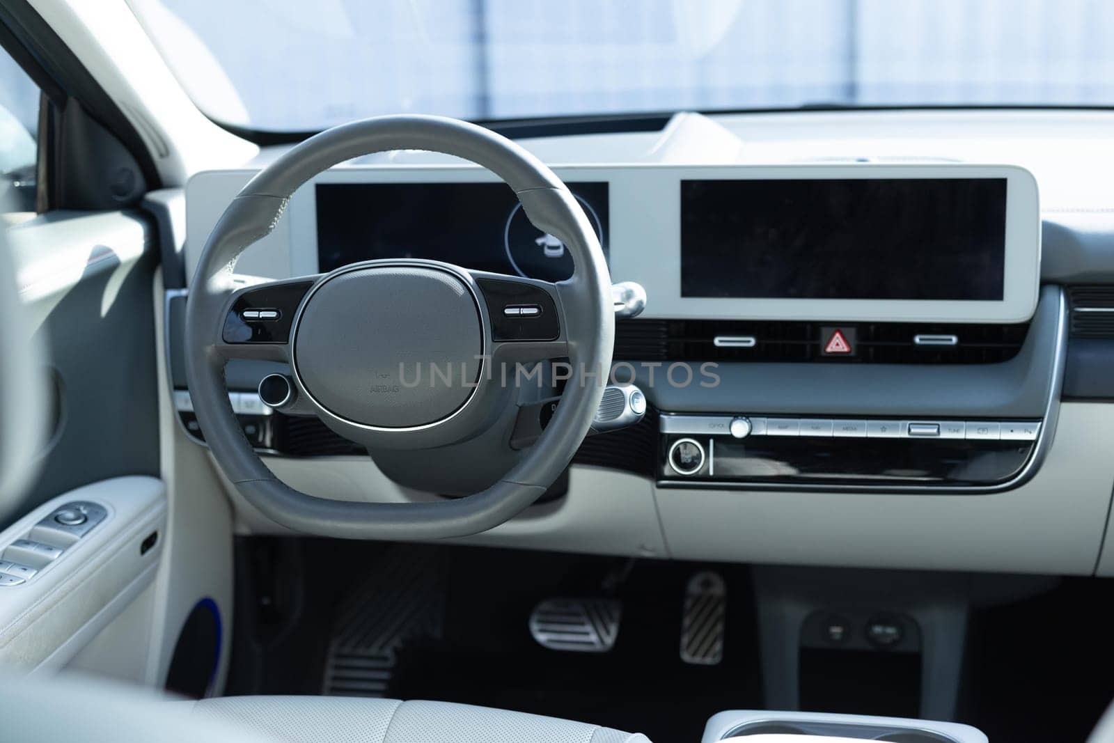 Electric car interior luxury. Interior of prestige modern car. Leather comfortable seats, dashboard and steering wheel. Cockpit with exclusive decoration.