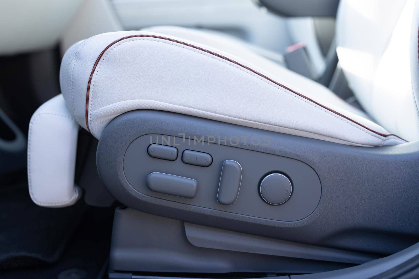 Driver's seat adjustment buttons. Buttons for adjusting seat position. Car interior. Furniture Adjustment Button Activated Power Seat Expensive White Leather.