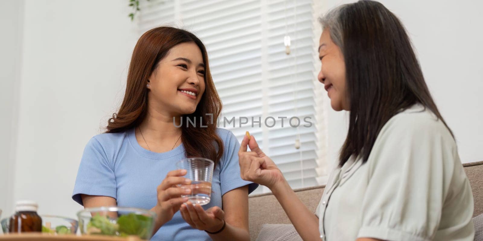 A happy moment where a mother shares nutrients info with her senior, facilitating an important conversation about health and wellness.